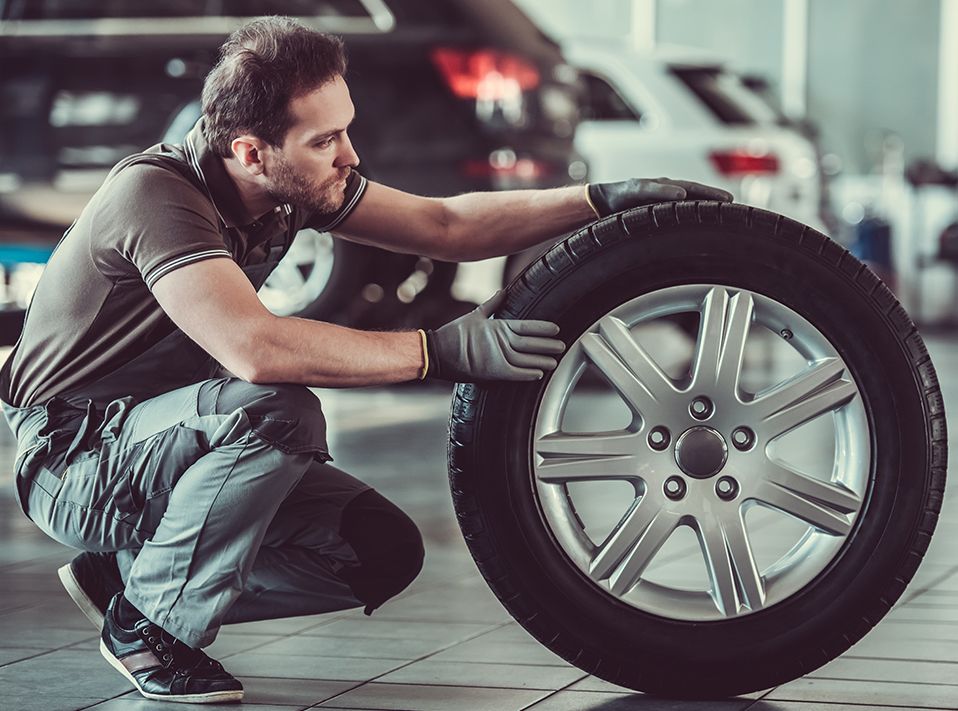 Mechanic inspecting a tyre - Tyres Northamptonshire